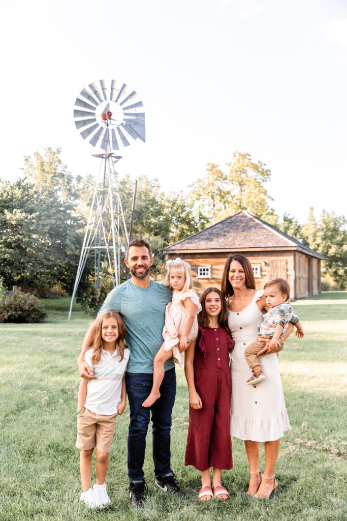 family portrait in front of windmill at Vehe Barn