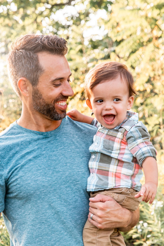 father holding son and smiling portrait