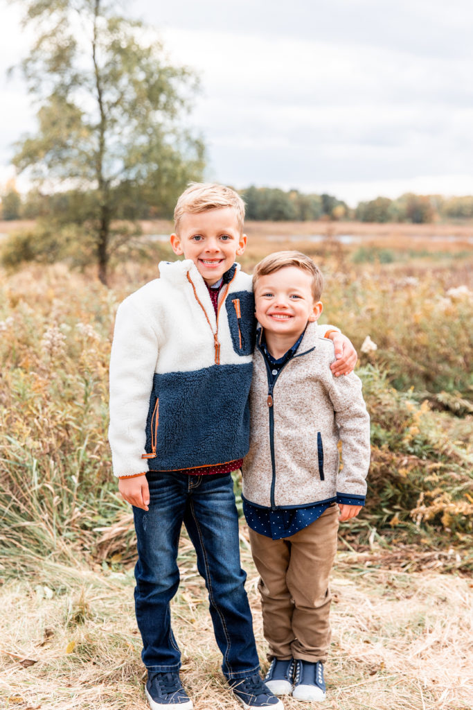 two brothers in a grassy field during a photography session