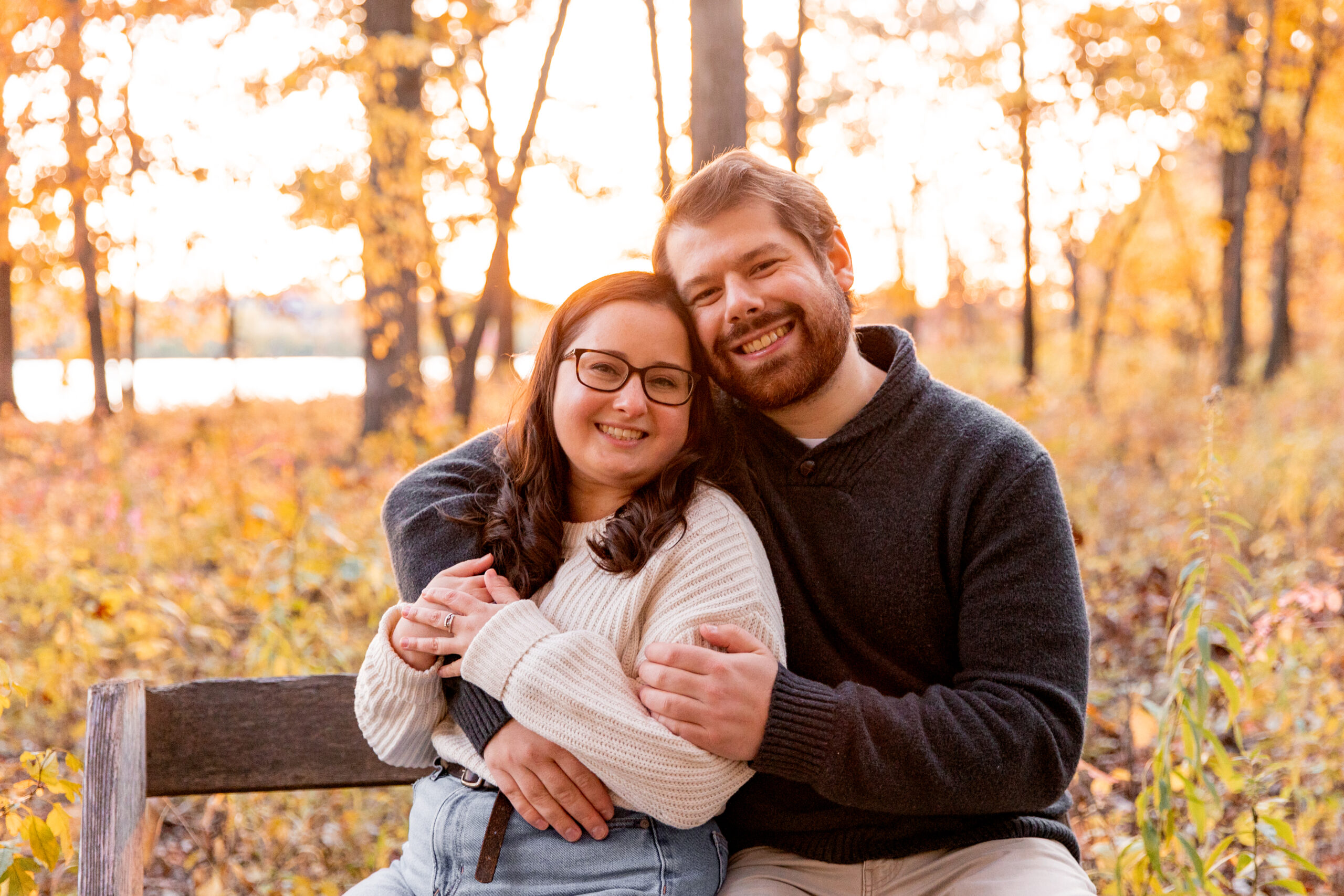 couple of photo on bench in fall colors during anniversary session